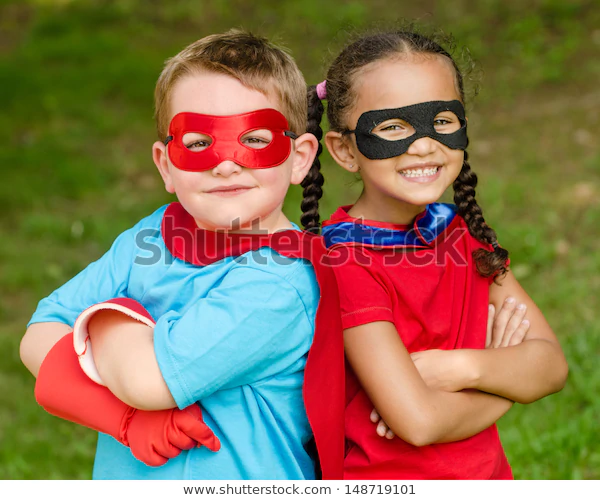Pretty mixed race girl and Caucasian boy pretending to be superhero