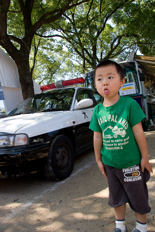 a patrol car and a kid